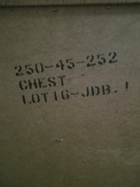 The serial number on the back of the chest of drawers.
