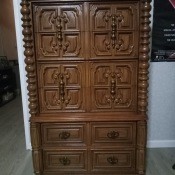 A tall wooden chest of drawers.