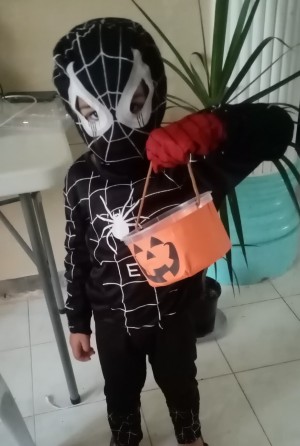 A costumed child holding a bucket.