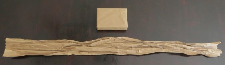 Crumpling the packing paper to make ribbon.