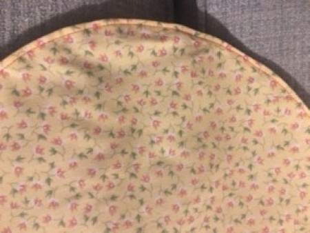 The sewn edge of the bottom of the basket.