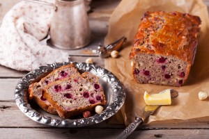 Cranberry nut bread loaf, with 2 slices cut.