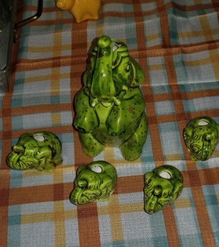 A small elephant figurine and 4 matching elephant tea light holders.