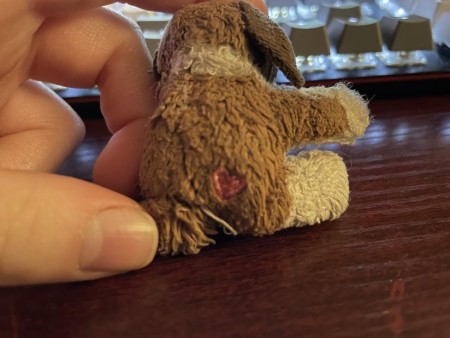 The back of a stuffed dog with a marking.