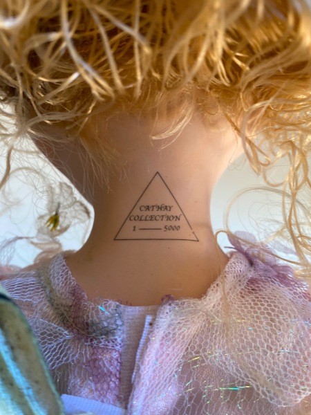 The marking on the back of a porcelain doll's neck.