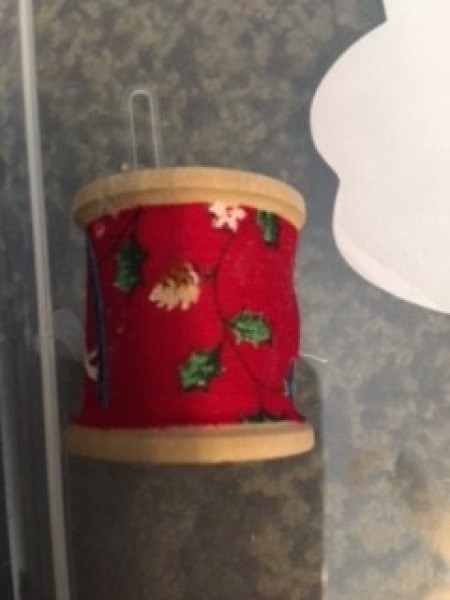 Covering the spool with ribbon.