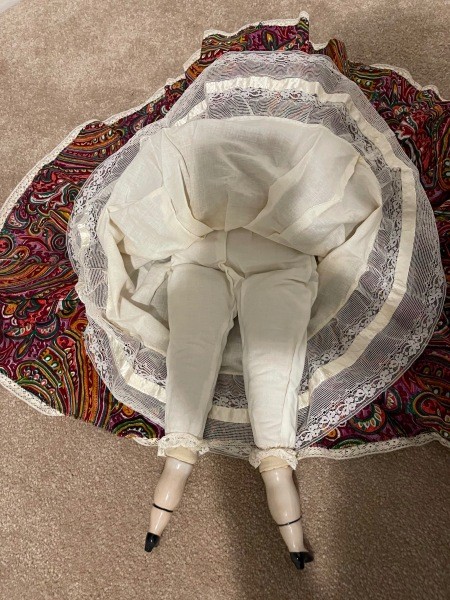 The underside of the porcelain doll.