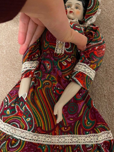 The doll with one broken hand.