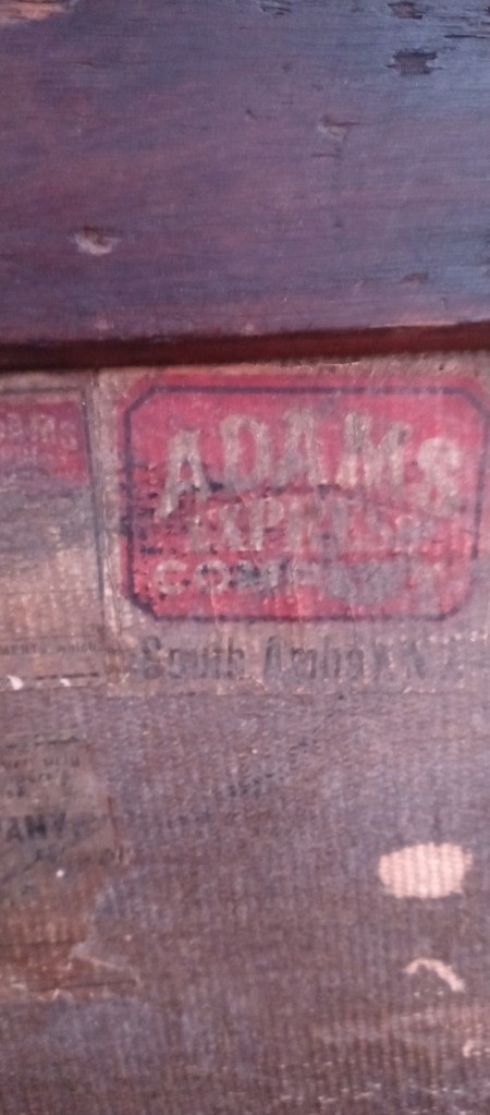 An Adams sticker on a steamer trunk.