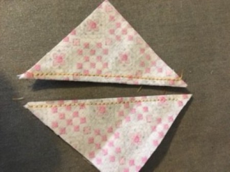 Two separate triangles of fabric.
