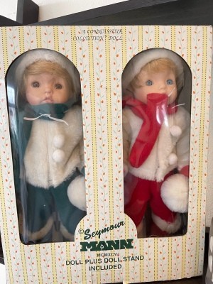 Twin dolls in matching winter outfits.