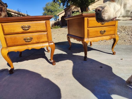 Two matching wooden end tables with two drawers each.