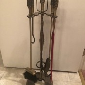 A set of brass fireplace tools.