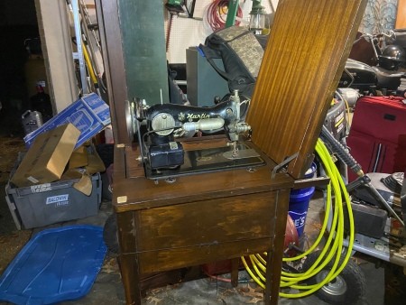 A sewing machine with a stand.