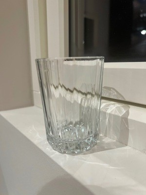 A clear glass with a ridged bottom.