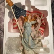 An angel figurine with an American flag.