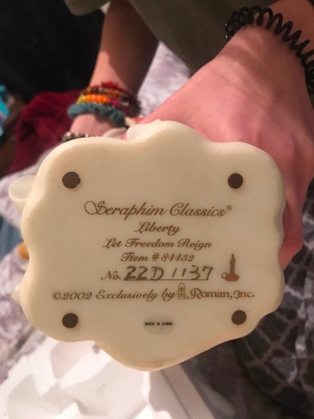The manufacturer's information stamped on the bottom of the figurine.