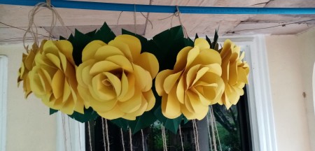 Adding flowers to the top of the chandelier.