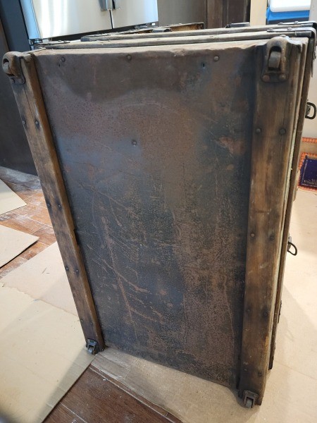 The underside of a steamer trunk.