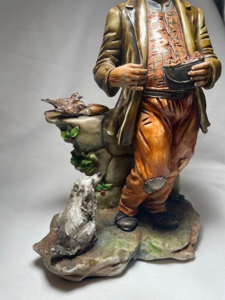 The lower half of a figurine of an older man.