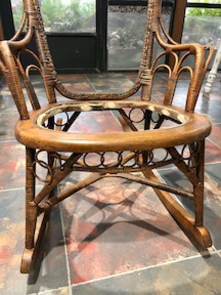 A rocking chair with the rattan missing.
