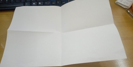 A piece of paper folded in half both ways.