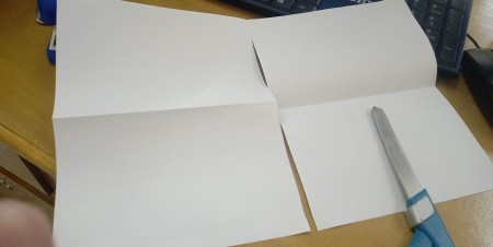 Cutting the paper in half.