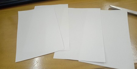 Stacking the pieces of paper together.