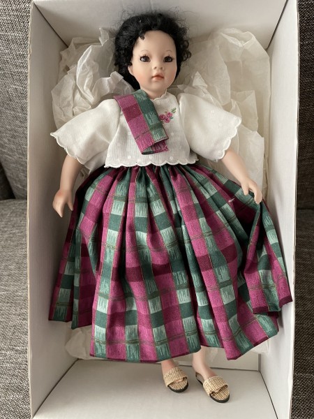 A porcelain doll in a box.