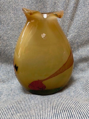 A yellow and red glass vase.