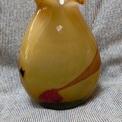 A yellow and red glass vase.