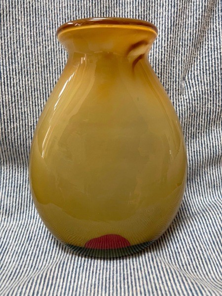 A yellow and red glass vase.