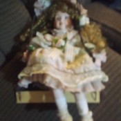 A porcelain doll on a swing.