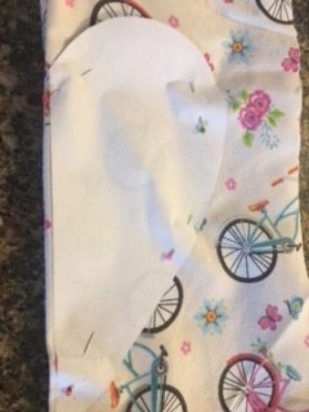 Attaching the pattern to folded fabric.