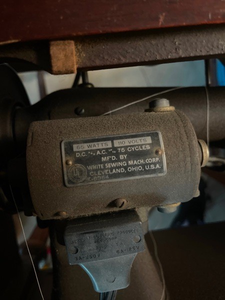 A close up of the informational plate on a sewing machine.