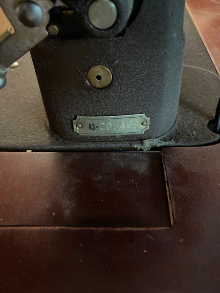 A close up of the informational plate on a sewing machine.