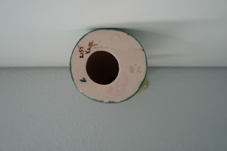 Markings on the underside of a figurine.