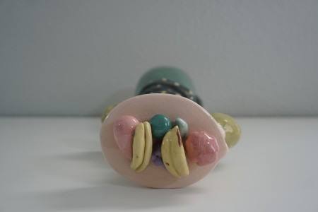 A plate of fruit on top of the figurine's head.