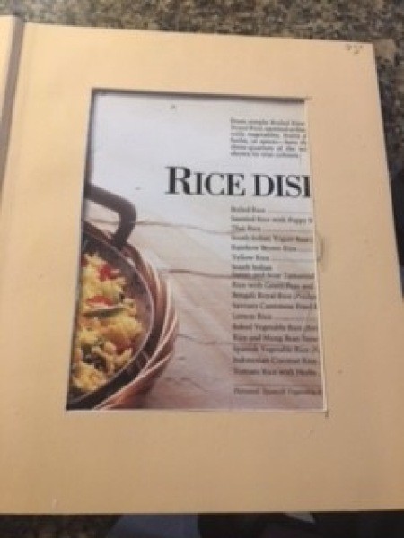 Cutting out a portion of the inside of the book.