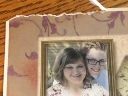 Tearing the edge of the paper covering the cover.