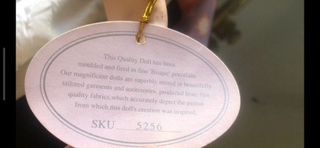 A tag on a porcelain doll.