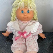 A doll with yellow yarn hair.