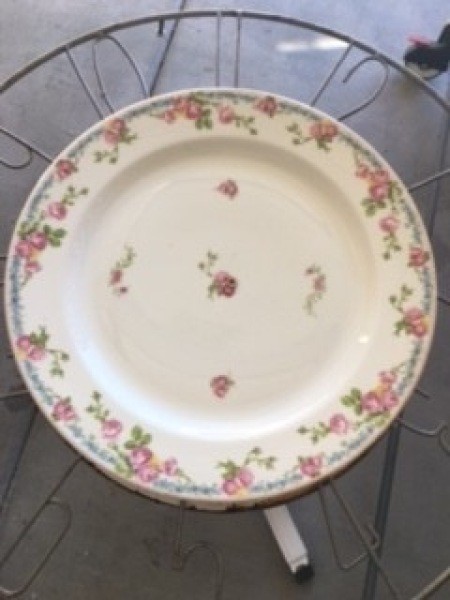 Placing the plate on top of the decorative wire frame.