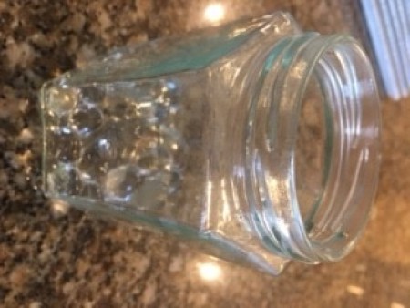 Adding the water beads to a jar.