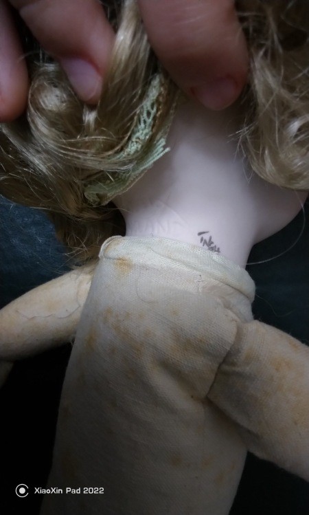 The marking on the doll's neck.