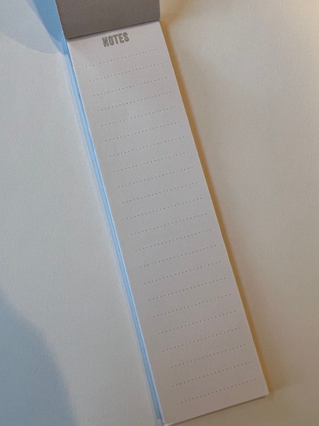 A long and skinny note pad.
