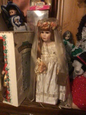 A porcelain doll with a bridal veil.