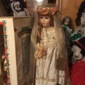 A porcelain doll with a bridal veil.