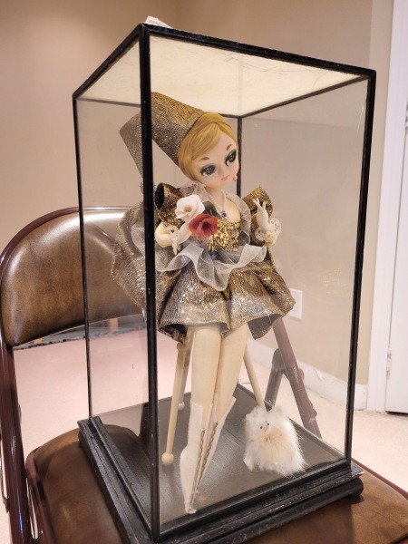An old Japanese doll in a glass case.