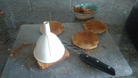 Cutting circles out of the toasted bread.